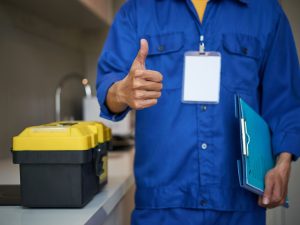 unrecognizable-male-plumber-standing-near-kitchen-sink-showing-thumb-up (2)